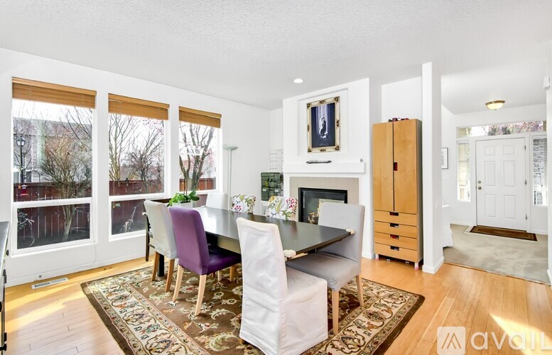 A dining room with a table and chairs.