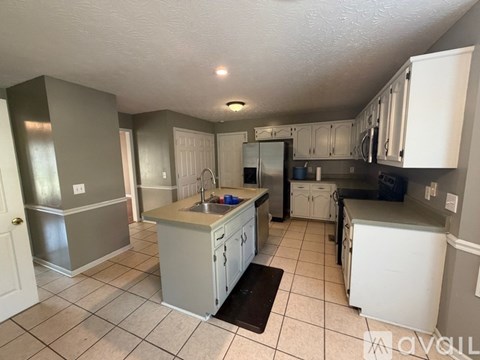 A kitchen with white cabinets and a sink.