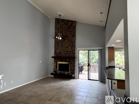 A living room with a fireplace and sliding glass doors.