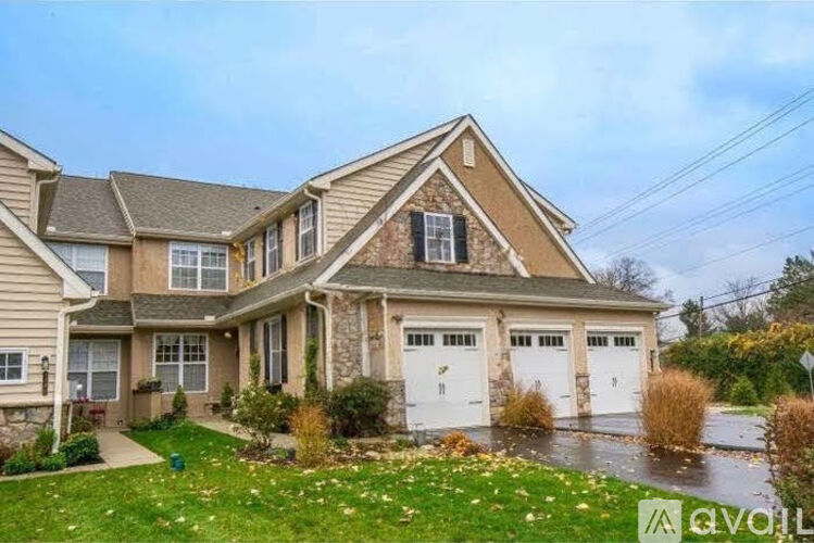 A house with a brown roof and a white garage door.