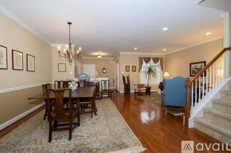A living room with a dining table and chairs.