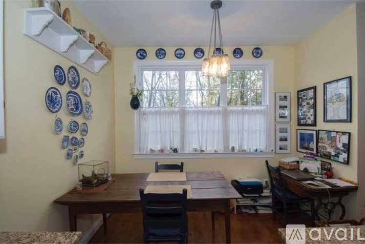 A dining room with a table and chairs.