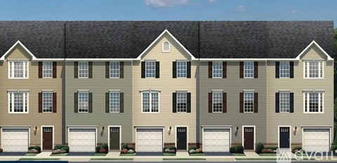 A row of townhouses with garages on the ground floor.