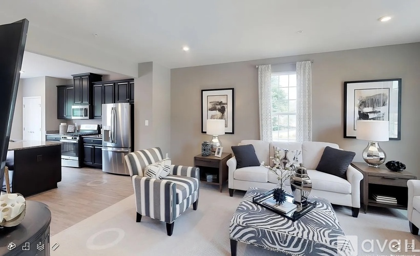 A living room with a black and white striped armchair, a white sofa, and a coffee table with a black tray on top.