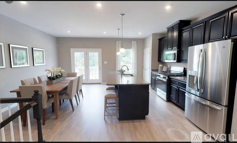 A modern kitchen with a dining table and chairs.
