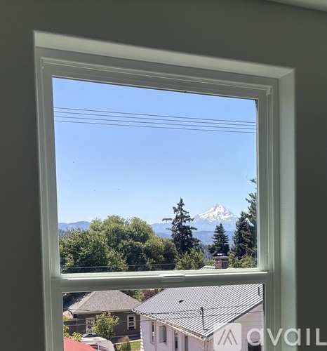 A window with a view of a mountain.