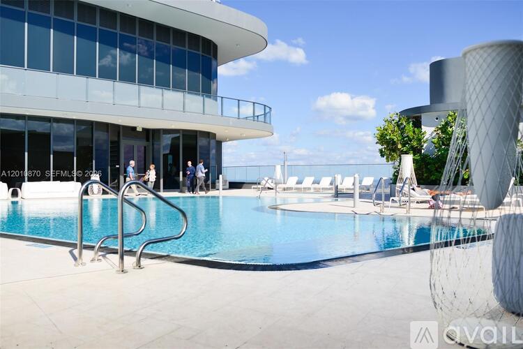A modern building with a pool in front.