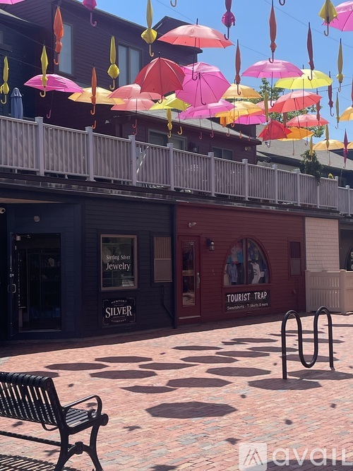 A bench is in front of a building with a sign that says "Silver Jewelry.".