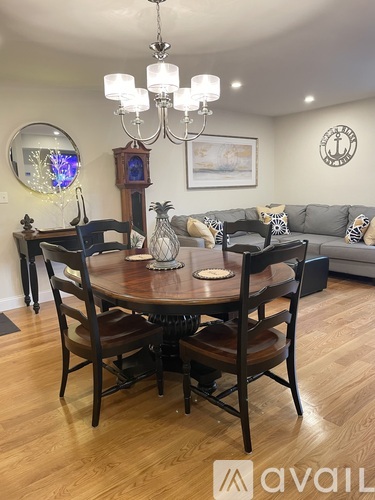 A dining room with a wooden table and chairs.