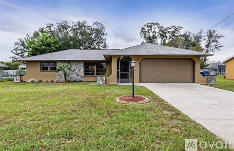 A house with a garage and a driveway in front.