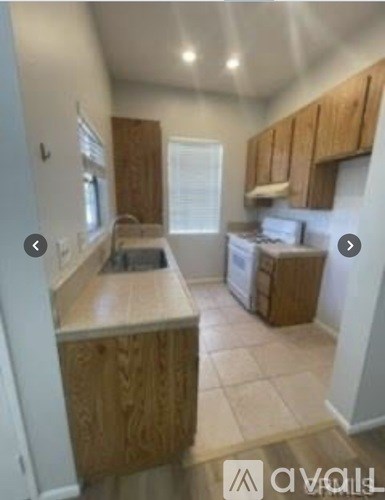 A kitchen with wooden cabinets and a countertop.