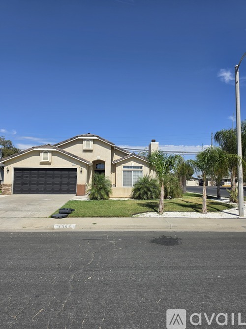 A house with a garage and a driveway in front.