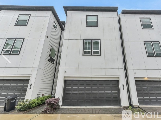 A modern building with three garage doors is available for rent.
