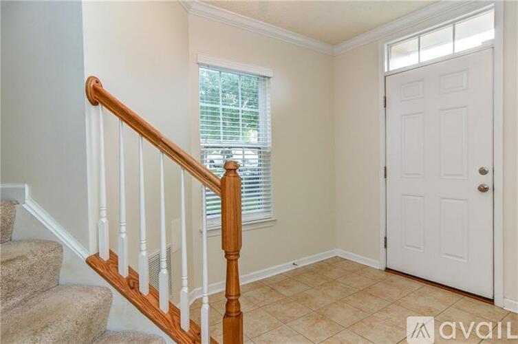 A room with a staircase and a door.