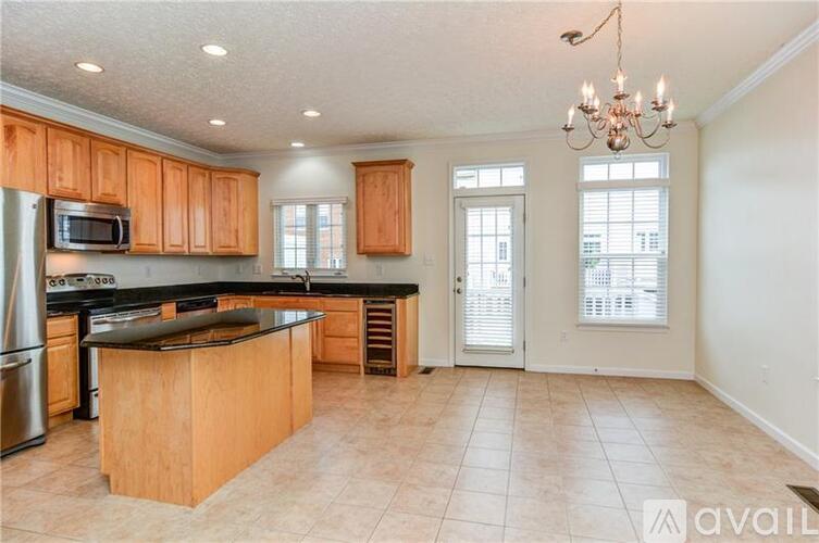 A kitchen with wooden cabinets and a black countertop.