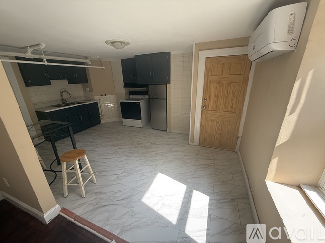 A kitchen with a black counter top and a white stove top oven.