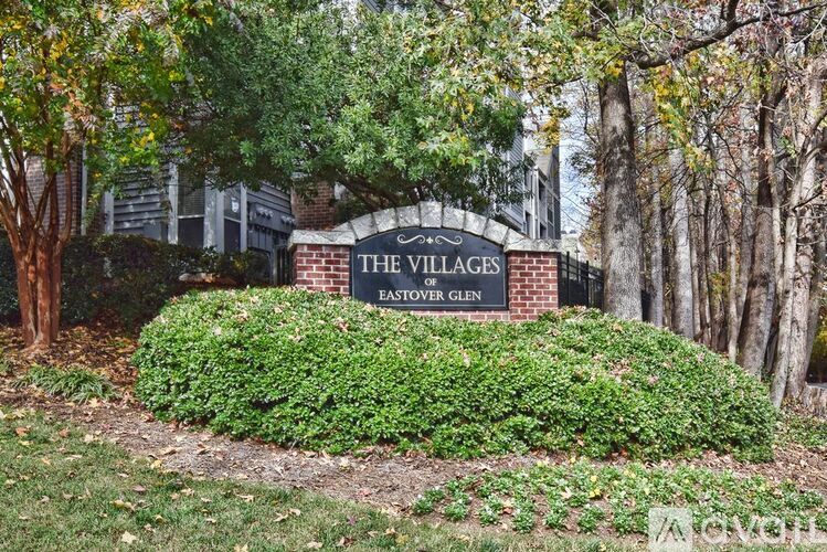 A sign that says "The Villages Eastover Glen" in front of a building.
