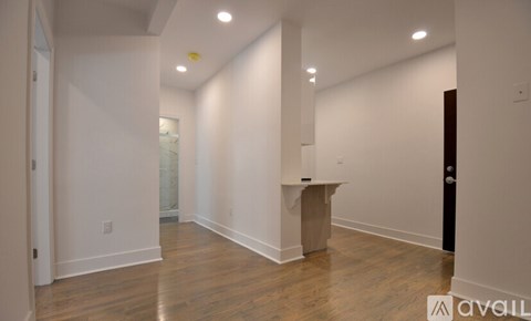 A room with wooden floors and white walls.
