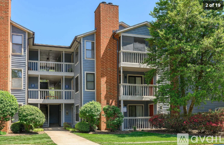 Apartments with balconies and a brick chimney are shown in the image.