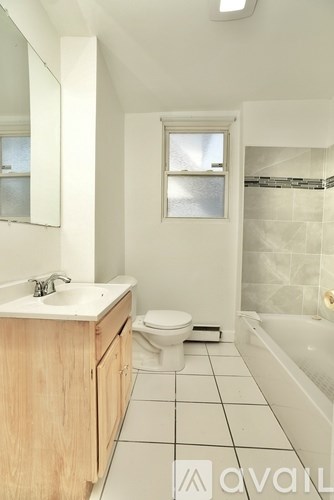 A bathroom with a toilet, sink, and bathtub.