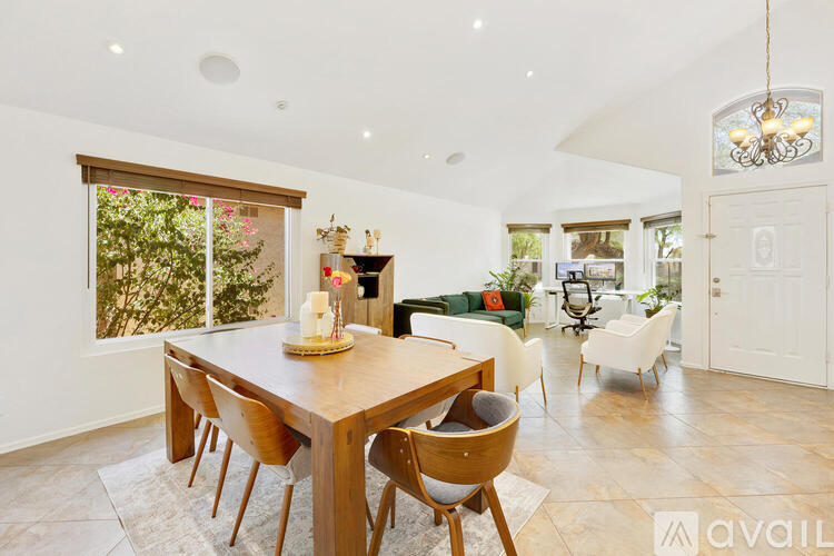 A dining room with a wooden table and chairs.
