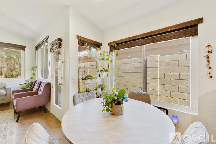 A living room with a round table and chairs.