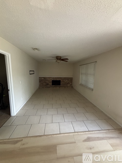 A room with a tiled floor and a ceiling fan.