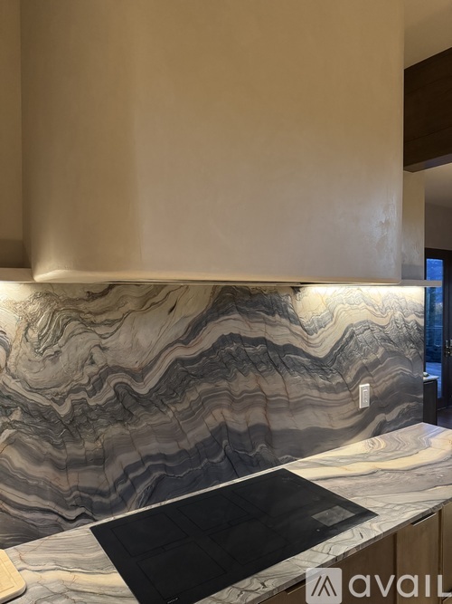 A kitchen countertop with a black cutting board on it.