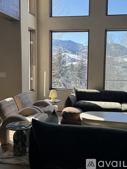 A living room with a view of snow-covered mountains.