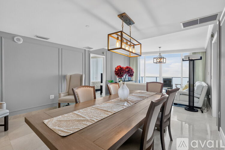 A modern dining room with a wooden table and chairs.