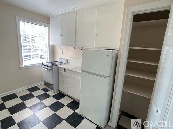 A kitchen with black and white checkered floor.