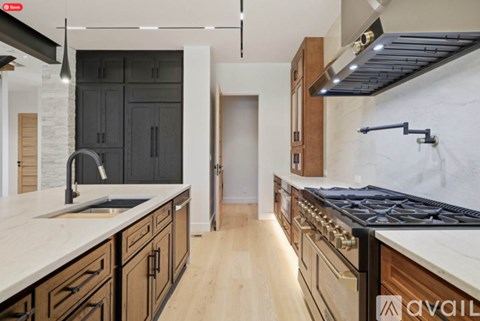 A modern kitchen with dark wood cabinets and a white countertop.