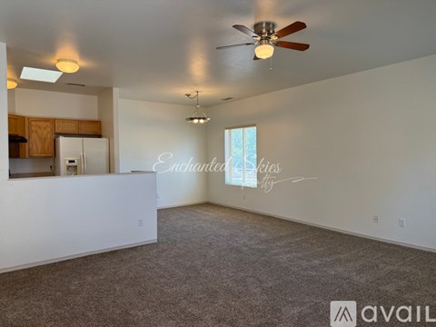Empty room with a ceiling fan and a window.