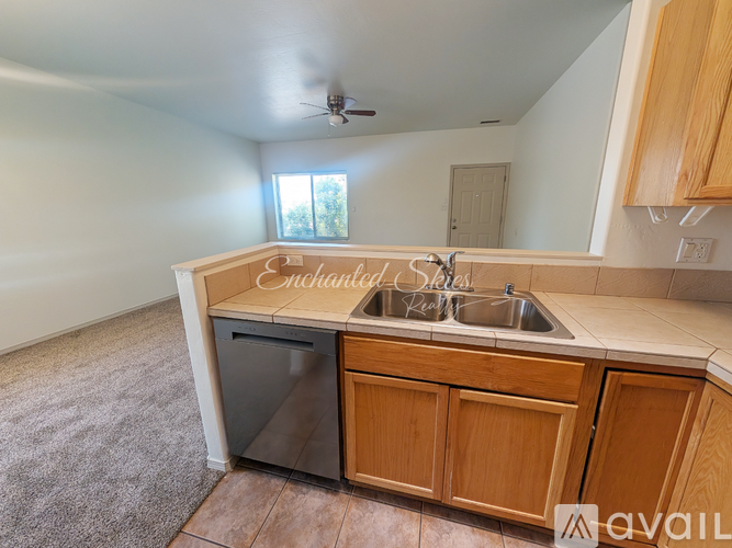 A kitchen with wooden cabinets and a sink.