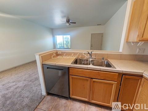 A kitchen with wooden cabinets and a sink.