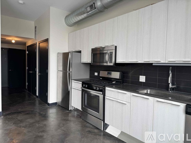 A kitchen with white cabinets and stainless steel appliances.