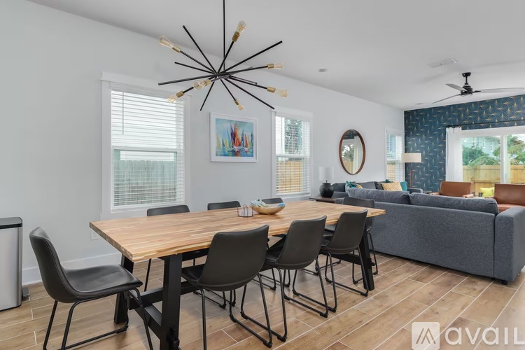 A modern dining room with a wooden table and chairs.