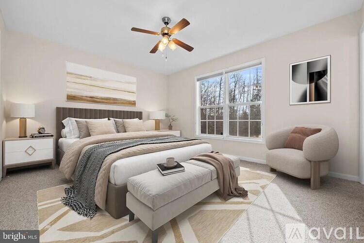 A bedroom with a large bed, a chair, and a ceiling fan.