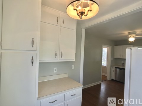 A kitchen with white cabinets and a countertop.