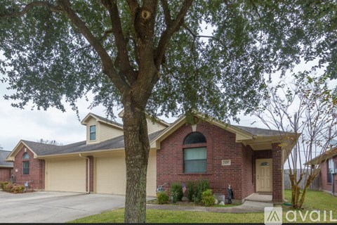 A house with a tree in front of it.