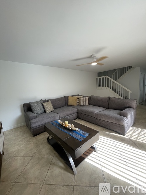 A living room with a grey couch and a coffee table.