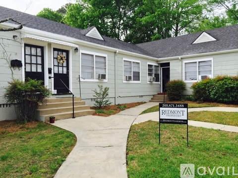 A house with a sign that says "Redmont" in front of it.