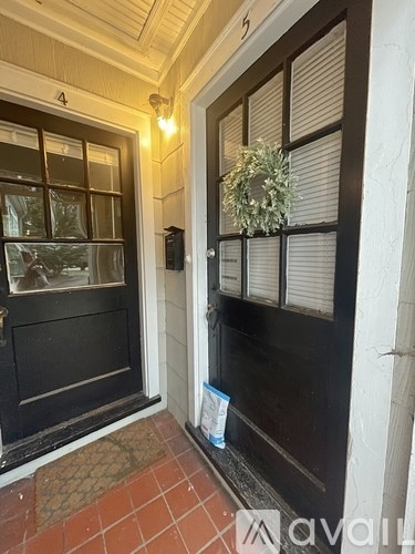 A door with a wreath on the window sill.