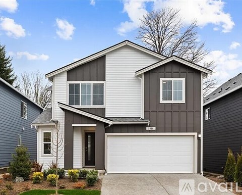 A two-story house with a garage is for sale.