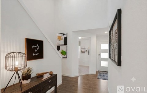 A modern interior with a wooden floor and white walls.