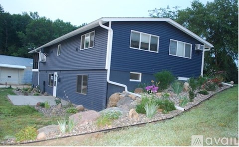 A blue house with a garden in front.