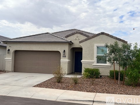 A house with a garage door and a driveway.
