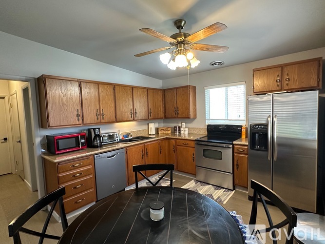 A kitchen with wooden cabinets and stainless steel appliances.