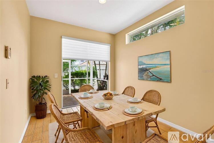 A dining room with a wooden table set for four.