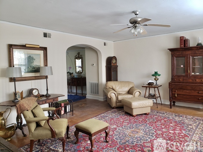 A spacious room with a fireplace and wooden flooring.